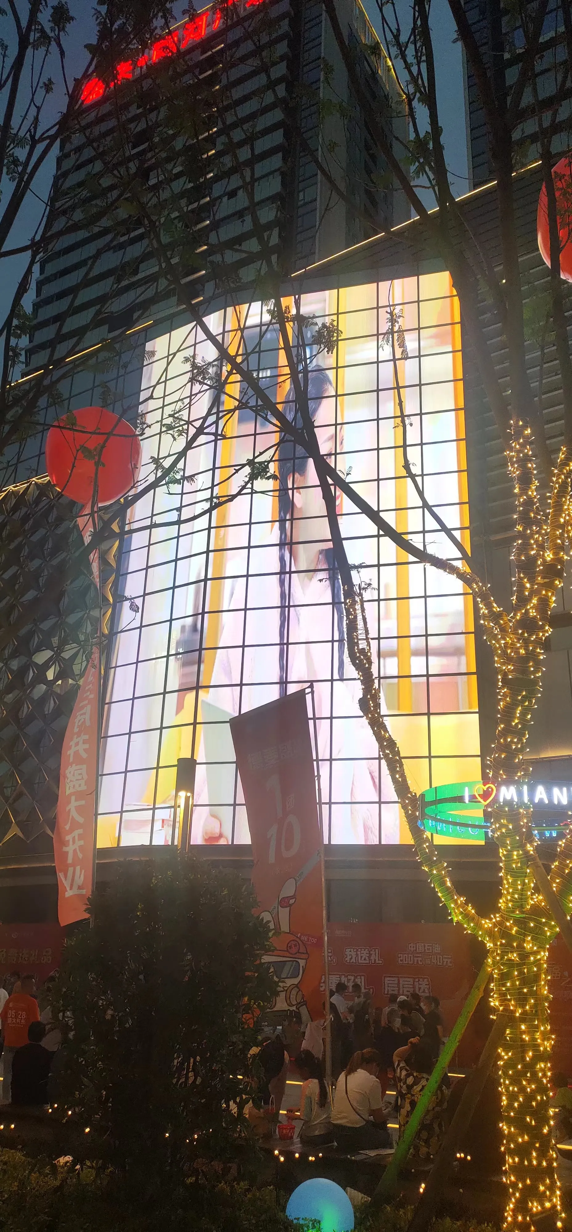 Transparent LED glass screen above a street frontage at night